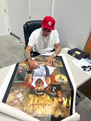 an original oil painting depicting basketball hall of fame legend allen iverson, with the artwork being signed by a man wearing a new york yankees cap.